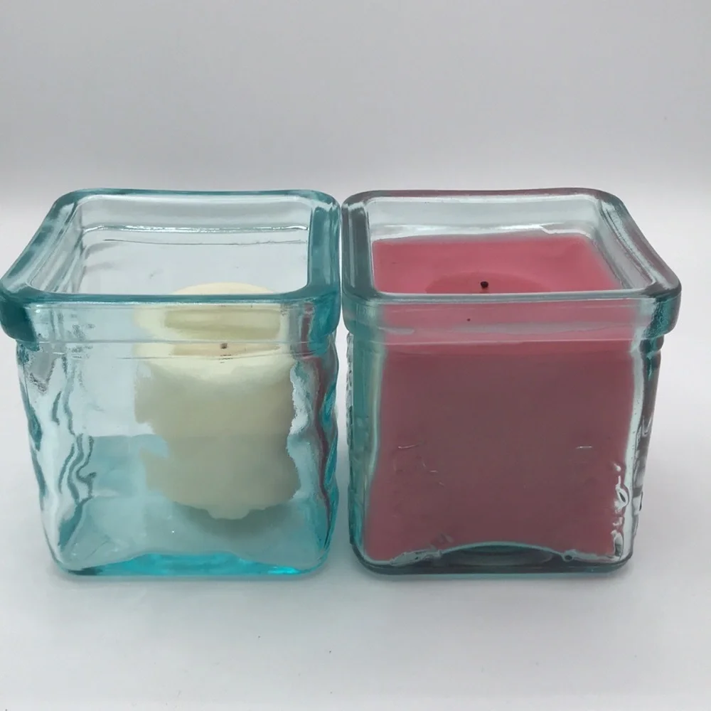 Two blue-green square glass candle holders